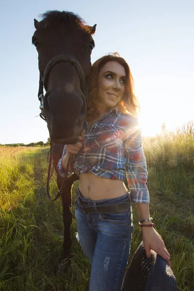 Žena a kůň na louce na letní večer — Stock fotografie