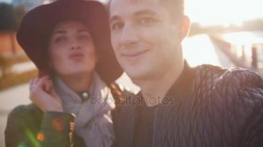 Genç adam ve onun karısı selfie gün batımında açık yapma