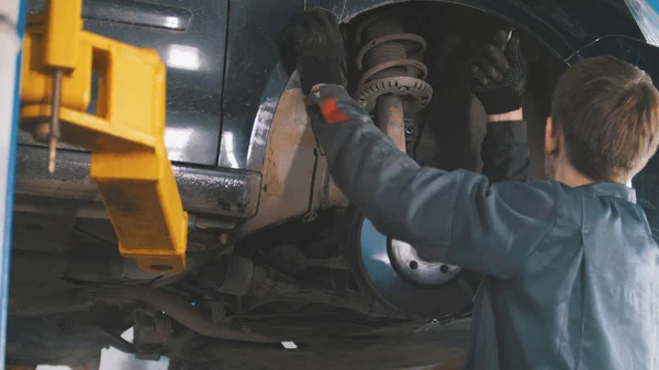 Car in auto service lifting for repairing