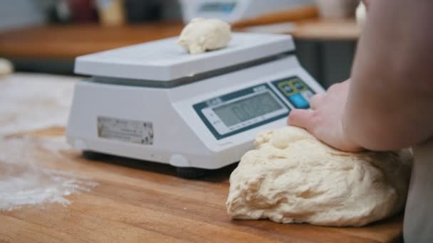 Baker weighing dough for baking — Stock Video
