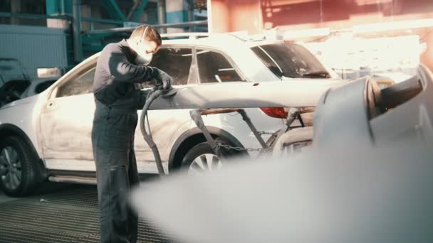 Hombre caucásico de mediana edad - trabajador haciendo trabajo manual en el servicio de automóviles - reparando el coche — Vídeo de stock