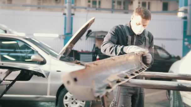 Процесс ремонта автомобиля - работник полировки детали автомобиля — стоковое видео