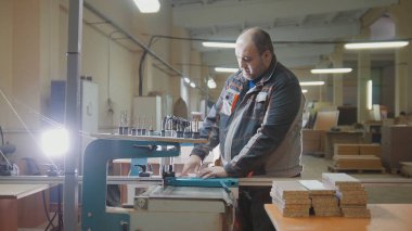 Ahşap bir parça kesip bir mobilya fabrikası işçisi marangoz