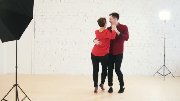 Middle age woman and young man is dancing kizomba in studio — Stock Video