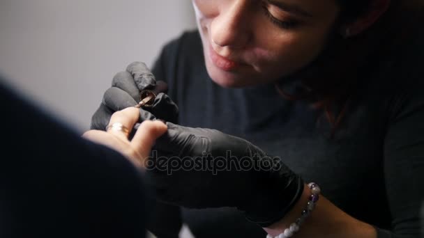 Nail master in medical mask doing professional manicure for white caucasian model, backlight — Stock Video