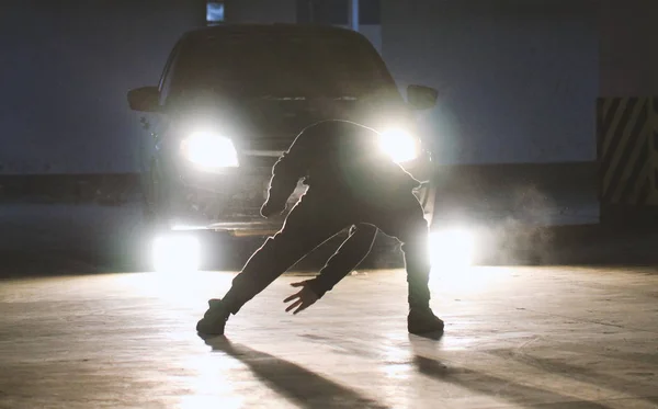 Teenager freerunner doing side flips in the garage, parkour acrobatic elements