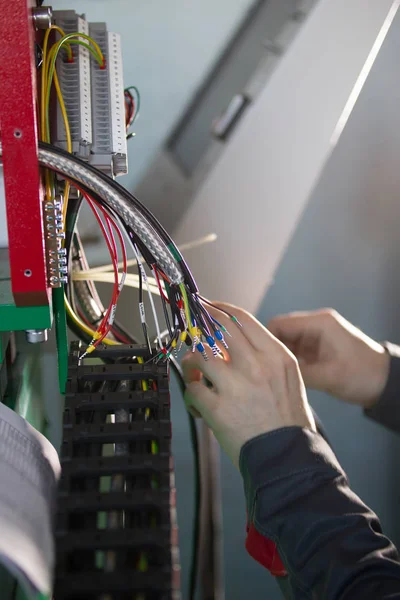 Hands of electrician engineer switching and testing equipment