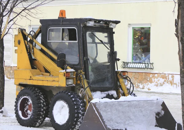 Snow bulldozer - clearing snow on the winter street