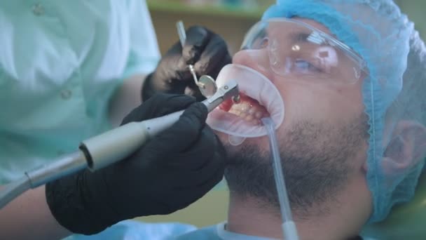 Stomatology clinic - patient male in dentistry chair — Stock Video