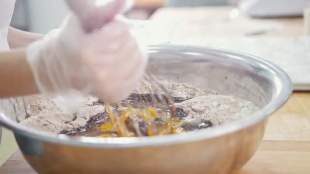 Пекарь в пекарне смешивает яйца и муку — стоковое видео