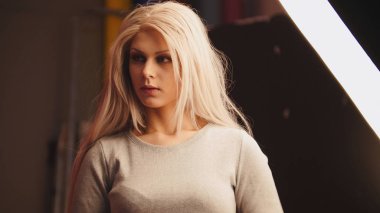 Genç sarışın kadın model için fotoğrafçı - moda sahne arkasında poz