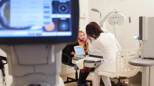 Healthcare - optometrist in ophthalmology clinic checking little childs vision