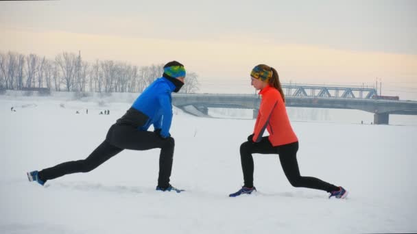 Grupo de atletas haciendo el ejercicio en el campo de invierno — Vídeos de Stock