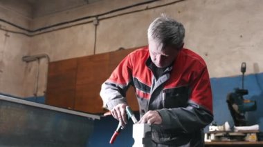 Bir tornavida ile metal parça elle montaj işçisi