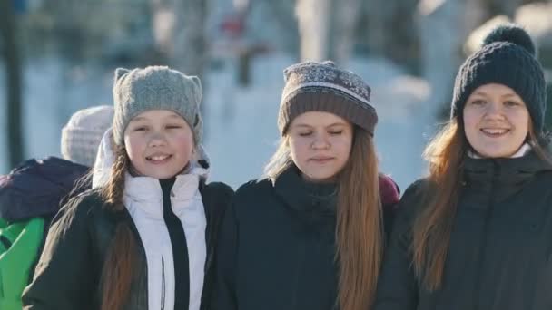 Πορτραίτο των τριών νεαρών κοριτσιών που φοράει χειμωνιάτικα ρούχα στο παγοδρόμιο — Αρχείο Βίντεο