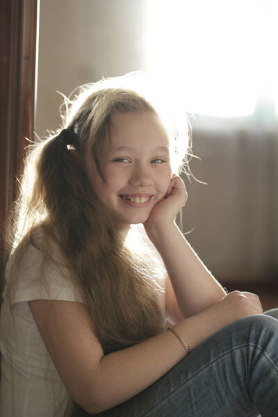 Teen girl posing for photographer at home