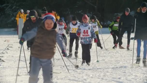 KAZAN, RUSSIA - MARCH, 2018: Children running on ski-track on ski marathon — Stock Video