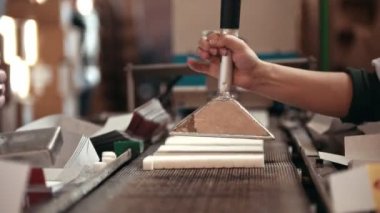 İşçi şeker üretim hattı üzerinden alır ve kutularına koyar