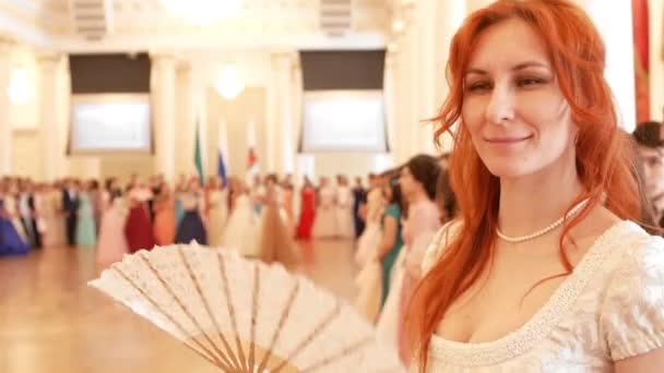 Young woman in vintage ball costume woman waving a fan — Stock Video