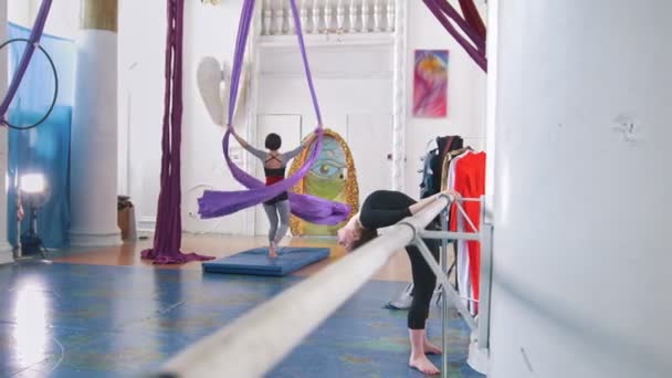 Young women trains air gymnastic in a studio — Stock Video