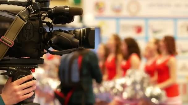 Camera in front of girls cheerleaders at the karate championship — Stock Video