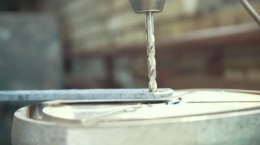 Atölye işçisi matkap Makinası ile metal bir plaka Delme