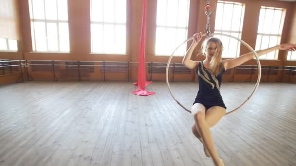 Hermosa bailarina balanceándose en el aro aéreo en un aula — Vídeos de Stock