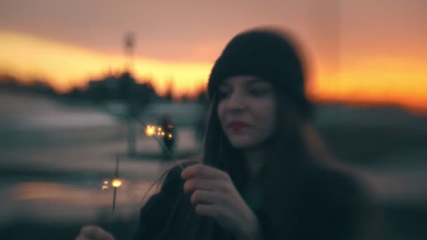 Ung kvinna att ha kul med tomtebloss i solnedgången — Stockvideo