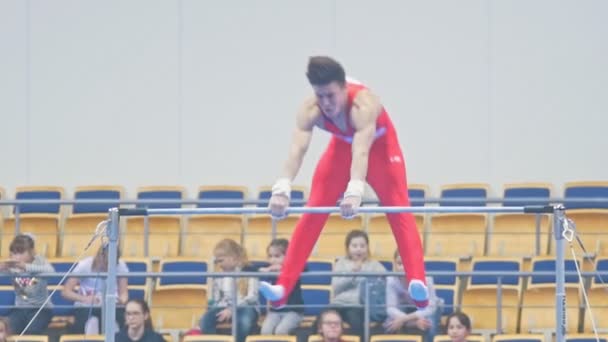 KAZAN, RUSIA - 18 DE ABRIL DE 2018: Campeonato de Gimnasia de toda Rusia - Joven gimnasta muscular realiza ejercicio con la barra — Vídeos de Stock