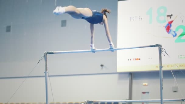 Kazan, Ryssland - 18 April 2018: All-ryska gymnastik championship - ung kvinna gymnaster tävlar på baren på mästerskapet — Stockvideo