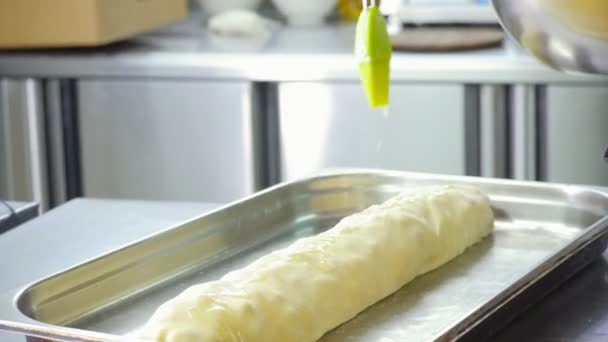 Making apple strudel - raw cake smeared with oil — Stock Video