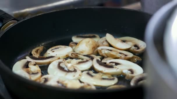 Chopped mushrooms fried in vegetable oil in the pan — Stock Video