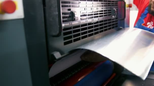 Trabajador pone la placa en la máquina de impresión de prensa — Vídeo de stock