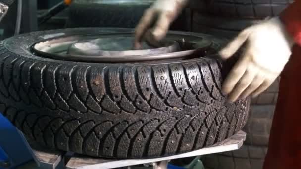 Repairing the tires - worker in car service - mechanical workshop — Stock Video