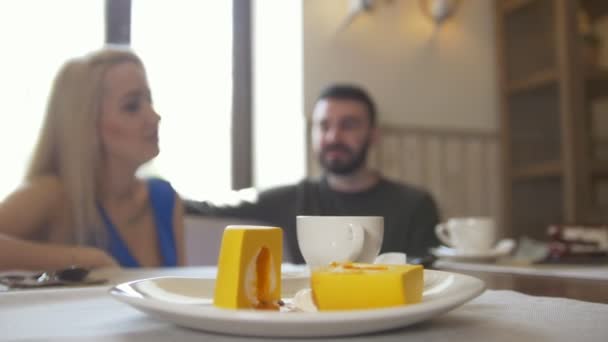 Süßes Dessert vor Pärchen, die sich im Café unterhalten — Stockvideo