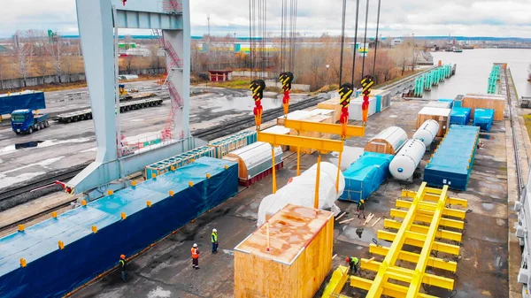 Port towarowy - duży dźwig przemysłowy wyładowujący ładunek z wagonów towarowych — Zdjęcie stockowe