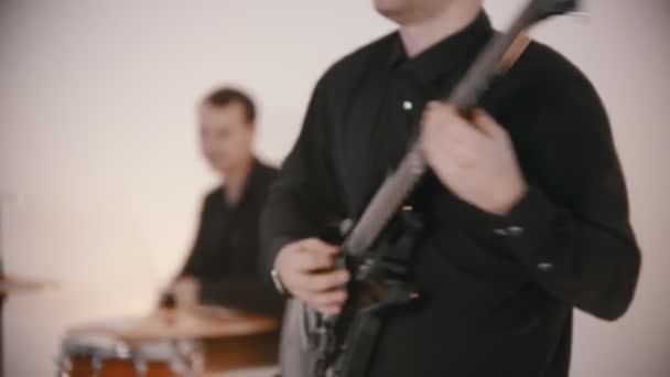 Zenei zenekar játszik - egy férfi gitáros és dobos játssza a szerepüket egy címdalban — Stock videók