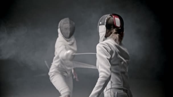 Fencing training - two young woman having a duel between each other — Αρχείο Βίντεο