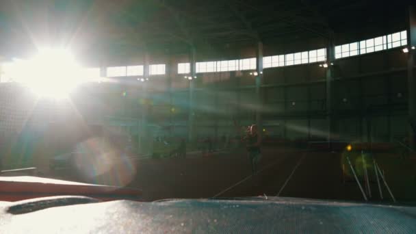 Pole vaulting - young woman is running and jumping over the bar — Stock Video