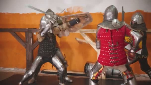 Four men knightes having a training fight indoors — Stock Video