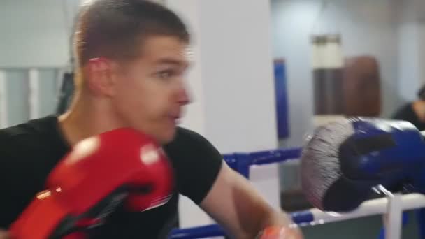 Boks - dwóch spoconych mężczyzn podczas agresywnej walki treningowej na siłowni — Wideo stockowe