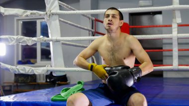 Kutu. Bir adam eline ikinci eldiveni takacak.