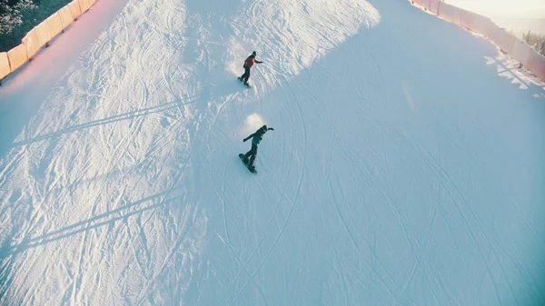 Snowboarding - people skating down the mountain outdoors — ストック写真