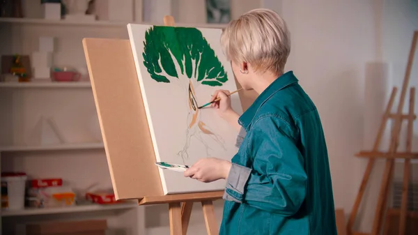 Młoda artystka kolorowanki jej obraz w studio sztuki — Zdjęcie stockowe