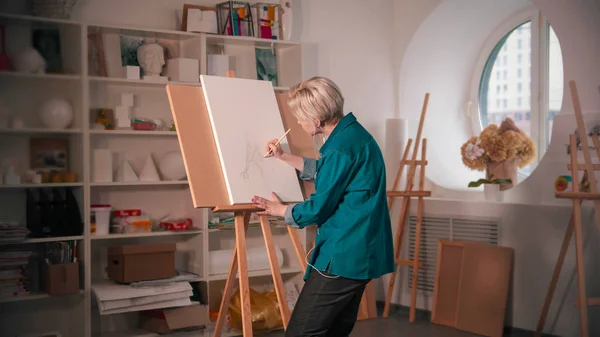 Молода жінка, що малює абстрактне дерево на білому полотні — стокове фото