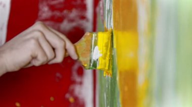 Fırça kullanarak sarı renkli boyayla boyanmış bir duvar. Yeni daire için özel iç tasarım.