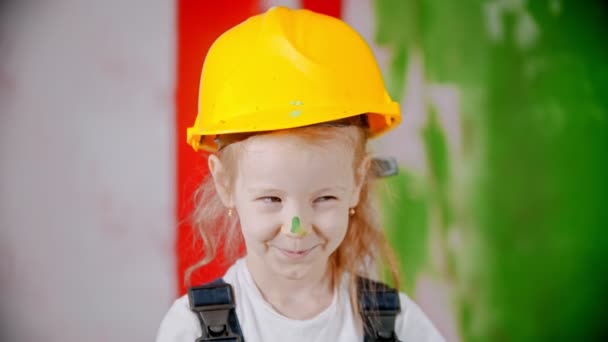 Sly girl with paint on her nose is looking at the camera — 图库视频影像