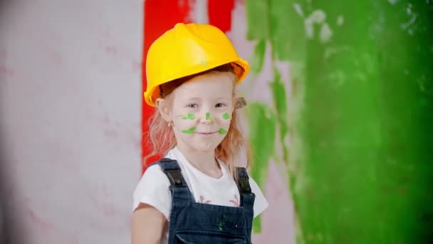 Girl with paint on her face is showing a fist to the camera — 비디오