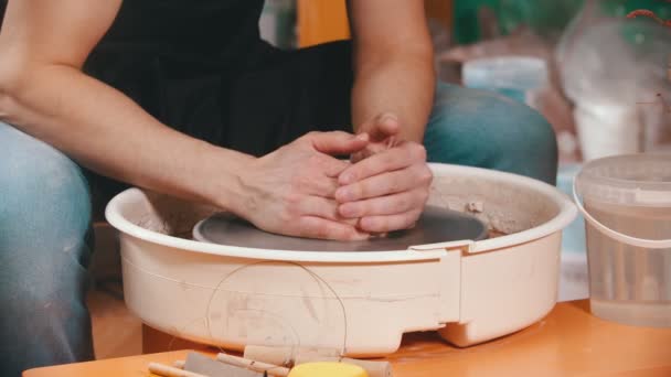 Poterie - le maître aux mains mouillées commence à tirer l'argile vers le haut — Video