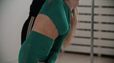 Two sportive women warming up at fitness training in the studio